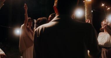 A group of people holding sparklers in the dark video