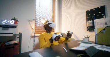 A man wearing a virtual reality headset in his office video