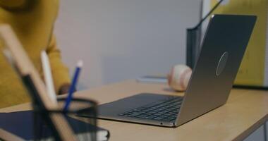 A person sitting at a desk with a laptop video