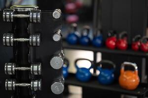 A pair of dumbbells neatly arranged in the gym, ready for a powerful workout session to build strength and endurance photo