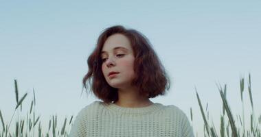 A woman in a field looking up video