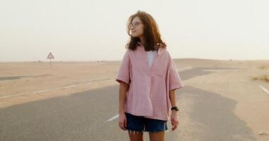 A woman standing in the middle of a desert video