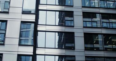 A building with many windows and a reflection of the sky video