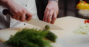A person cutting vegetables on a cutting board video