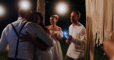 A couple is hugging in front of a group of people video