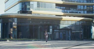 A man walking in front of a building video