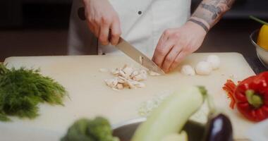 A chef cutting vegetables on a cutting board video
