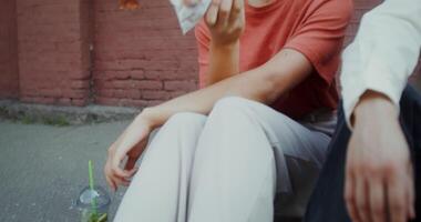 A woman sitting on the ground with a man video