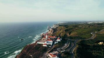 An aerial view of a lighthouse on a cliff overlooking the ocean video