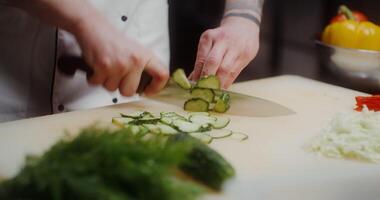 A chef cutting cucumbers on a cutting board video