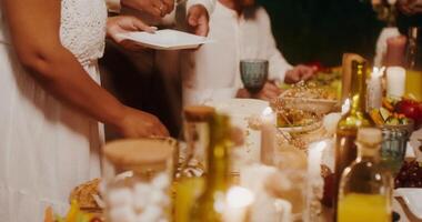 A group of people are serving food at a dinner party video