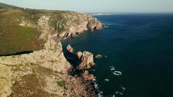 Aerial view of cliffs and ocean in the middle of the day video