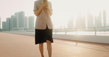 A woman in a suit standing on a dock with a city in the background video