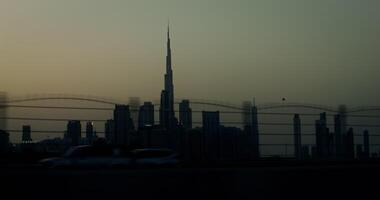 The silhouette of a modern metropolis with skyscrapers. from a moving car window at dusk video