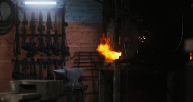 A man is working on a furnace in a factory video