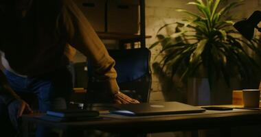 A man is standing in front of a laptop computer video