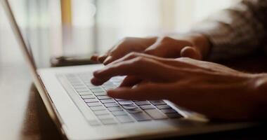A person typing on a laptop computer video