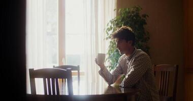 A young woman of European appearance in casual clothes is typing on the computer while working from home. Remote work in quarantine conditions, shooting close-up video