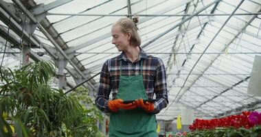 A woman in an apron is holding a pair of gloves video