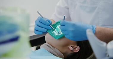 A person is getting their teeth cleaned by a dentist video