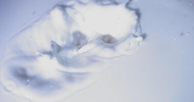 A close up of a white liquid splashing into a bowl video