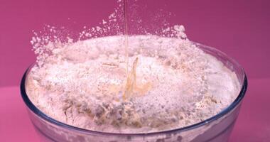 A blender filled with flour being poured into it video