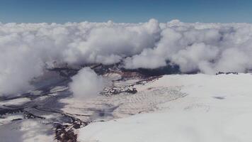 An aerial view of snow covered mountains and clouds video