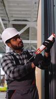 Construction worker applying sealant to wall panel video