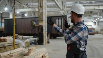 Worker directing modular home transportation in factory video
