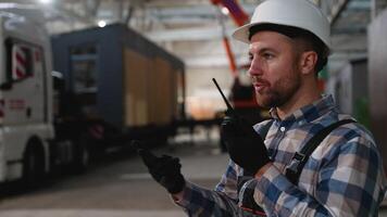 Construction worker giving instructions via walkie-talkie while managing the transportation of a modular home video