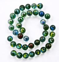 A collection of toy marbles arranged in a unique half-circle with a white back. art background. Unique art. Unique photo. Toy marbles design. photo