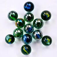A collection of colorful marbles arranged to form a flower pattern on a white background. art background. Unique art. Unique photo. photo