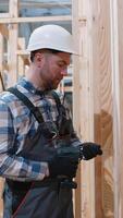 Construction worker assembling wooden modular house frame video