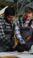 Engineers analyzing blueprints for modular home construction video