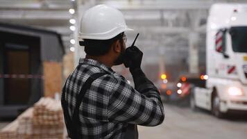 Indian worker coordinating modular home loading process video