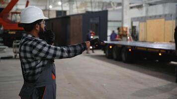 Indian worker directing modular home loading onto trailer video
