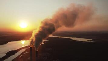 Large plant with smoking pipes. Dark smoke comes out in clouds from chimney of factory plant video