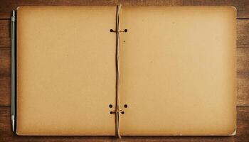 Open Vintage Brown Kraft Paper Notebook on Rustic Wood Background Top View photo
