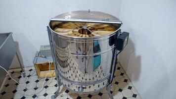 Honey extractor at beefarm. Honey extractor spinning with frames with honeycombs video