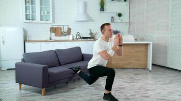 Man doing exercise at home. Young man practicing fitness at home video