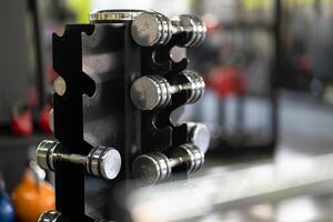 A pair of dumbbells neatly arranged in the gym, ready for a powerful workout session to build strength and endurance photo