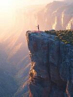 A man standing on top of a cliff with a red flag photo