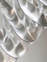 Curved transparent surfaces reflecting light in subtle waves photo