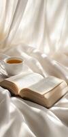 Cozy afternoon with a book and tea on soft fabric photo