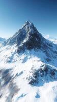 Majestic snow-capped mountain rises under clear blue sky photo