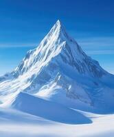 Snow-covered mountain peak with clear blue sky and sunlight photo