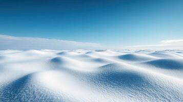 Snow-covered landscape under a clear blue sky in winter photo