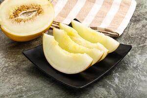 A melon on a plate with a towel on it photo
