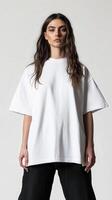 Model posing in oversized white shirt against plain backdrop photo