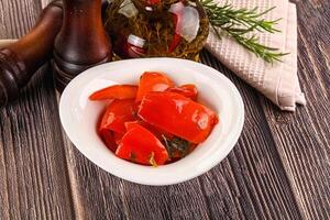 A bowl of red peppers and a pepper grater photo
